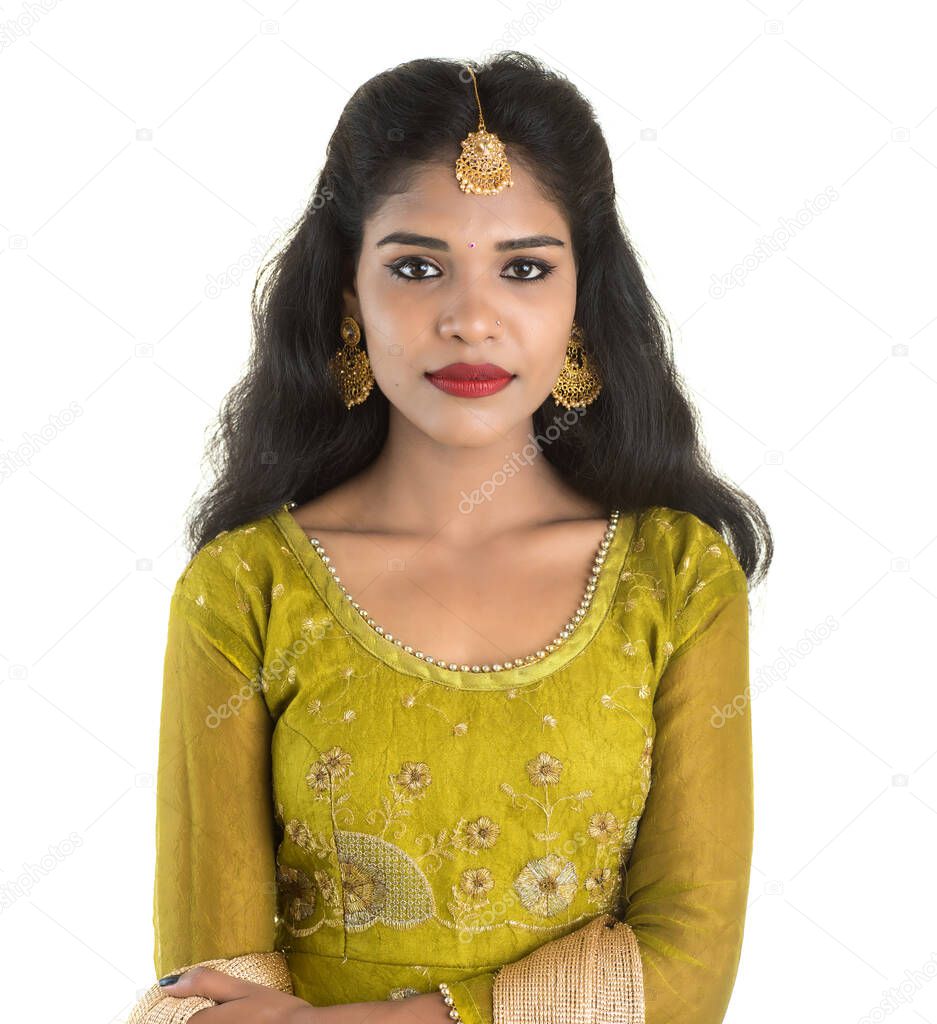 Portrait of beautiful traditional Indian girl posing on white background.