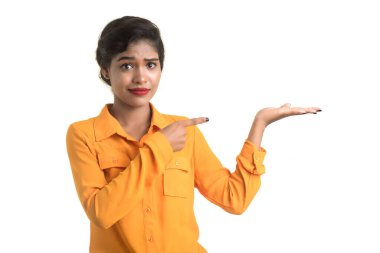 Güzel bir kız elinde mutlu bir gülümsemeyle bir şey tutuyor..