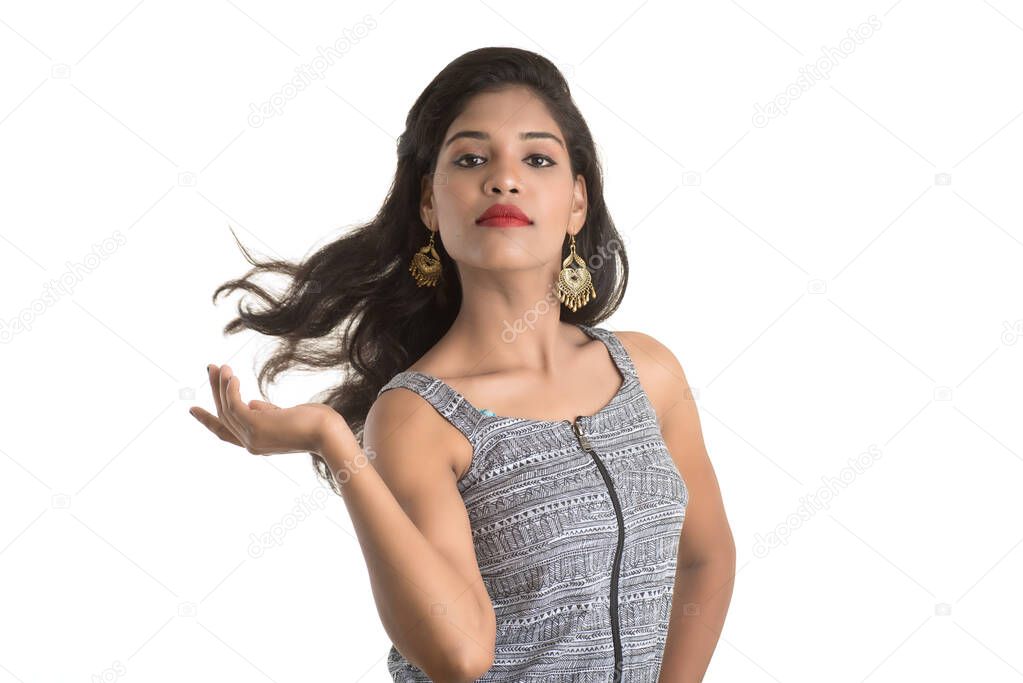 Portrait of beautiful young smiling girl posing on white background