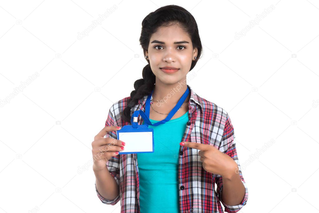 Young woman holding Identification white blank plastic id card.