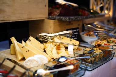 Wide Variety of Sliced Cheese on Wooden Desk