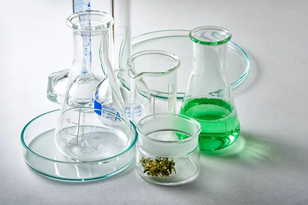 Laboratory Glassware with Marijuana Bud in Small Glass Container — Stock Photo, Image