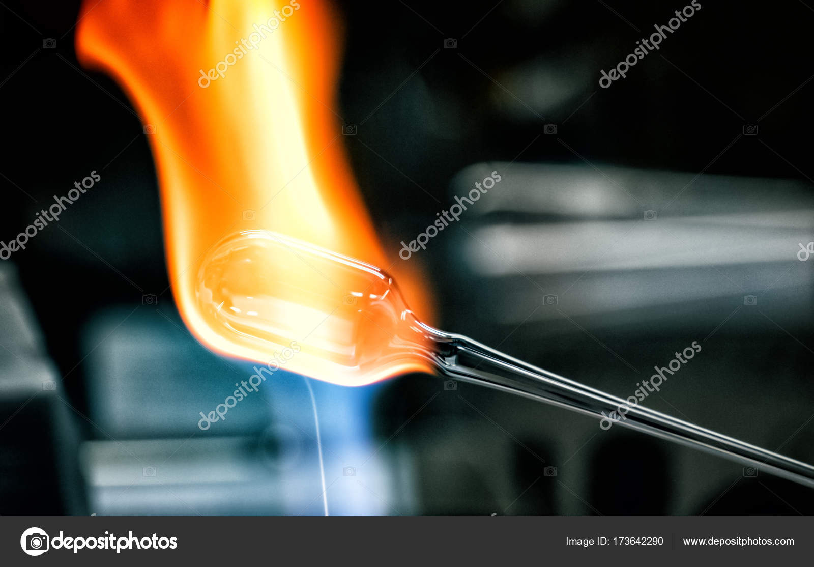 Glass blower forming a chemistry glass, closeup view, glass blower