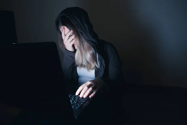 Sad and female teenager with tablet computer and laptop suffering cyberbullying and harassment being online abused by stalker or gossip feeling desperate and humiliated in cyber bullying — Stock Photo, Image