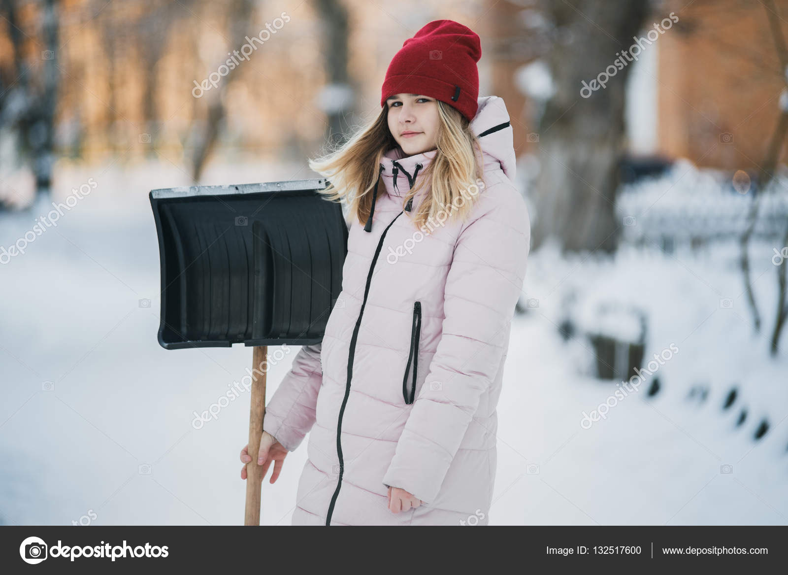 Young Teen Girl Cleans Snow Near The House Holding A Shovel And Paddle Spend Time Young Teen Girl Cleans Snow Near The House Holding A Shovel And Paddle Spend Time