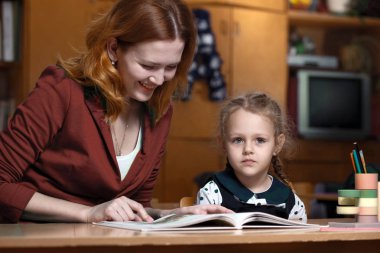 mother and daughter reading books