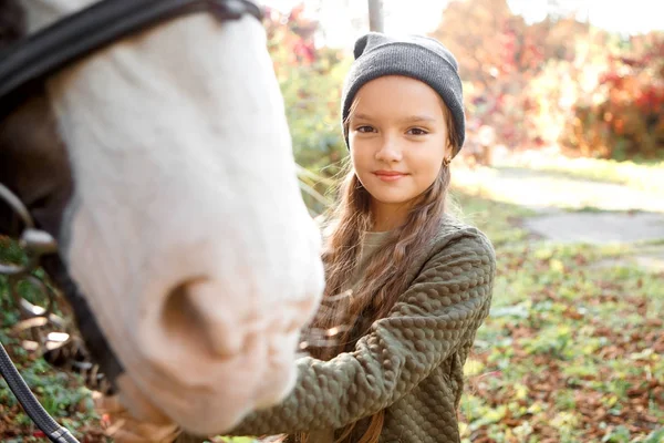 Portrait of beautiful girl with a chestnut pony — Stock Photo, Image