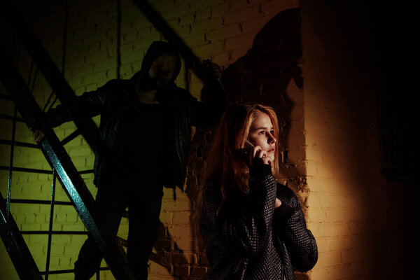 young sad vulnerable girl using mobile phone scared and desperate suffering online abuse cyberbullying being stalked