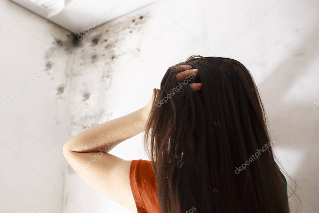 Close-up Of A Shocked Woman Looking At Mold