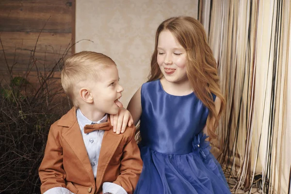 Sister and brother stick out tongues to each other — Stock Photo, Image