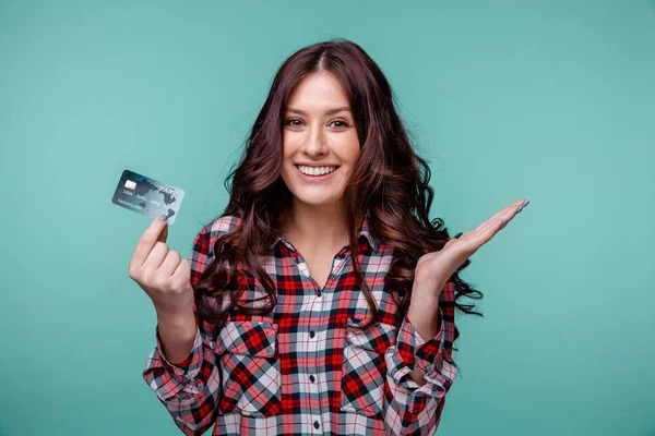 Ładna dziewczyna trzyma karty kredytowej na białym tle niebieski. — Zdjęcie stockowe