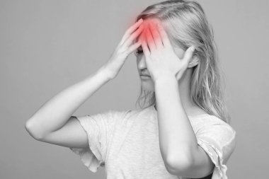 Stresli, mutsuz, başı ağrıyan genç bir bayan..