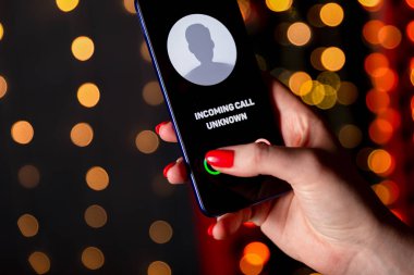 Phone call from unknown number. Scam, fraud or phishing with smartphone concept. Prank caller, scammer or stranger. Woman answering to incoming call. Hoax person with fake identity