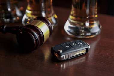 Drinking and driving concept. Car key on a wooden table, pub clipart
