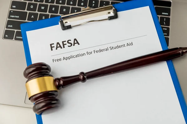 Document with student aid and wooden gavel on the table with laptop isolated. Fafsa