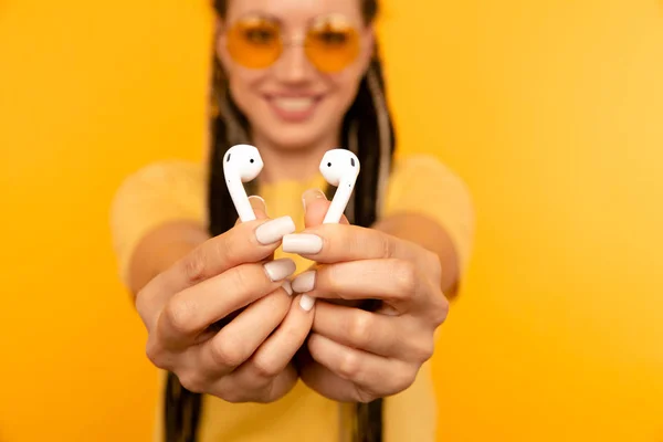 Young woman showing airpods closeup. — Stock Photo, Image