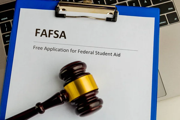 Document with student aid and wooden gavel on the table with laptop isolated. Fafsa