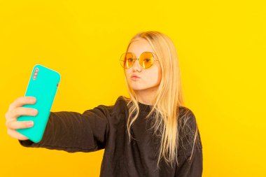 Evde kameranın önünde vlog için konuşan mutlu kız. Blogcu olarak çalışan genç, İnternet için video dersi kaydediyor.