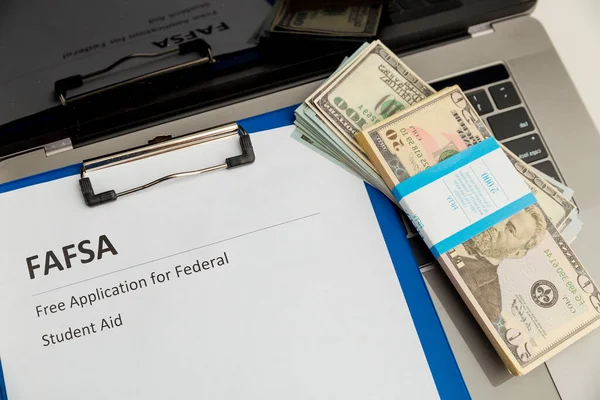 Fafsa. Öğrenci yardımı beyannamesi ve tablet üzerindeki para.