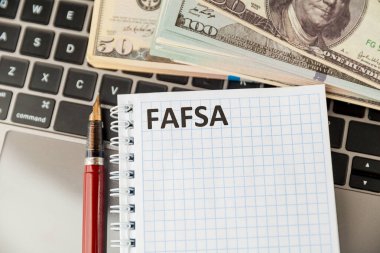 Fafsa. Öğrenci yardımı beyannamesi ve tablet üzerindeki para.