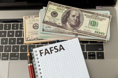 Fafsa. Student aid. Money on the table. clipart