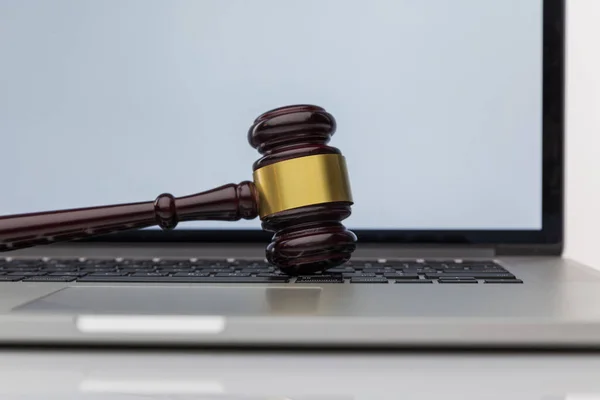 Workspace of lawyer with laptop blank white screen and law wooden gavel,legal book and brass scale of judge. lawyer and law ,judiciary and legislature courtroom legal concept.