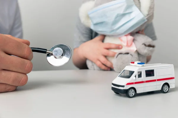 Man kinderarts met kind speelgoed met behulp van stethoscoop in de kast. — Stockfoto