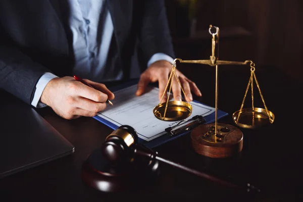 Lawyer office. Statue of Justice with scales and lawyer working on a laptop. Legal law, advice and justice concept.