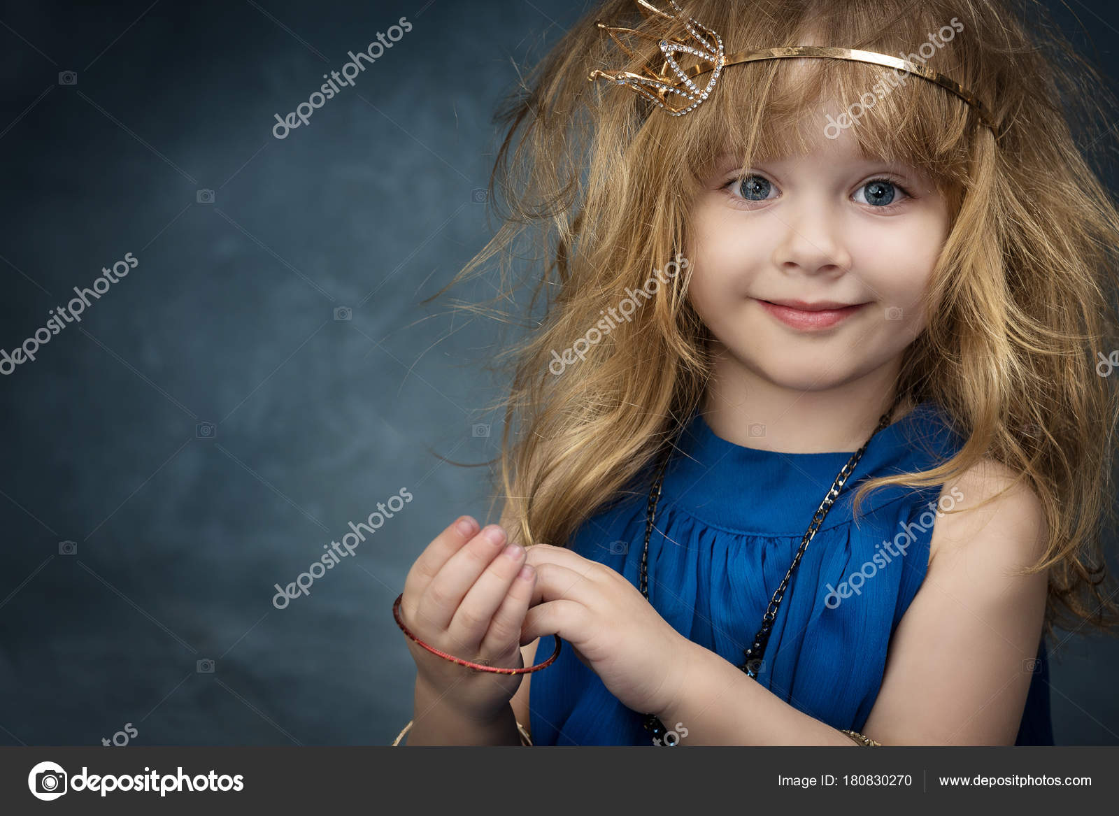 Charming Little Girl With Her Hair In The Blue Dress And The Crown