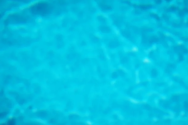 La textura del agua en la piscina color azul imagen borrosa — Foto de Stock