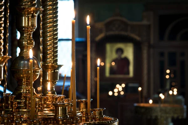 candles in the Church on the background of the icon and the window