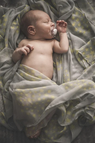 Śpi noworodek leżąc na łóżku, owinięte w szalik Obraz Stockowy