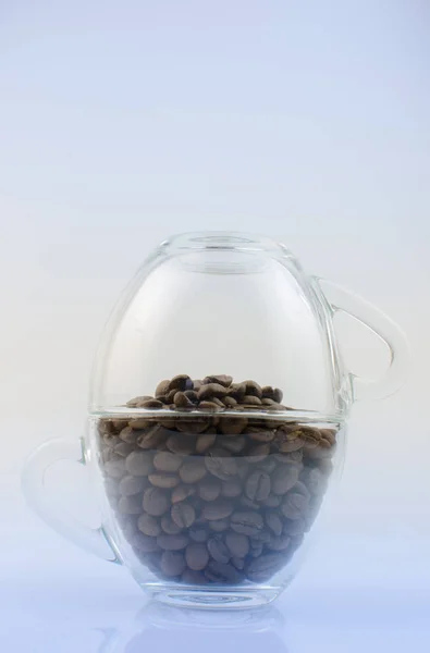 Coffee beans in transparent mugs — Stock Photo, Image