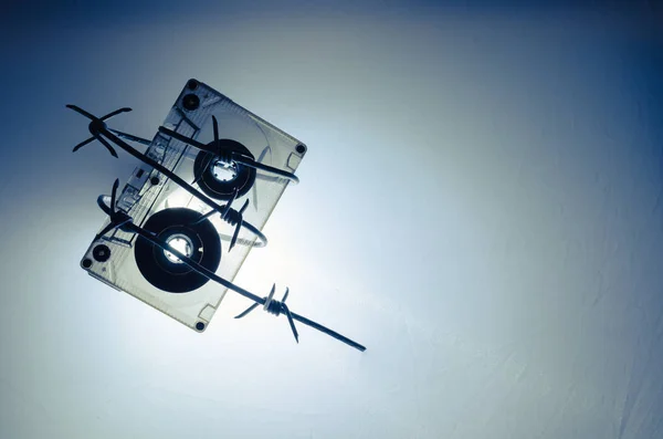 Audio cassette wrapped in barbed wire — Stock Photo, Image