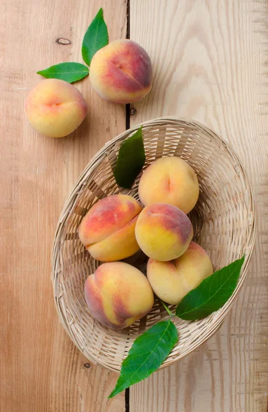 Peaches in a wicker basket — Stock Photo, Image