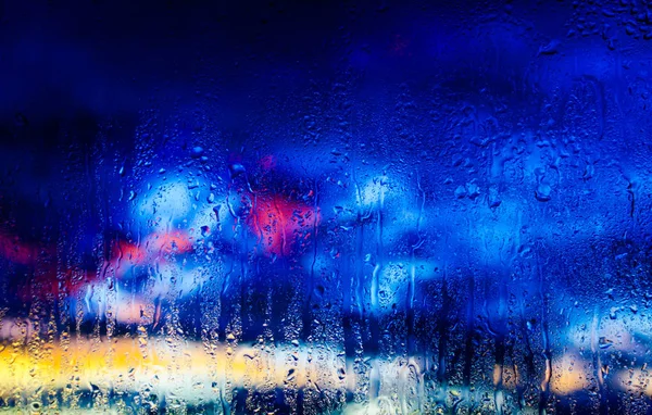 Sunset after the rain through a wet glass — Stock Photo, Image