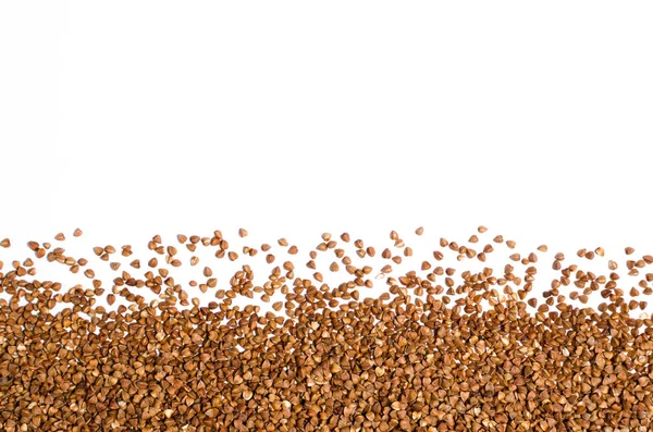 Dispersión de trigo sarraceno sobre fondo blanco — Foto de Stock