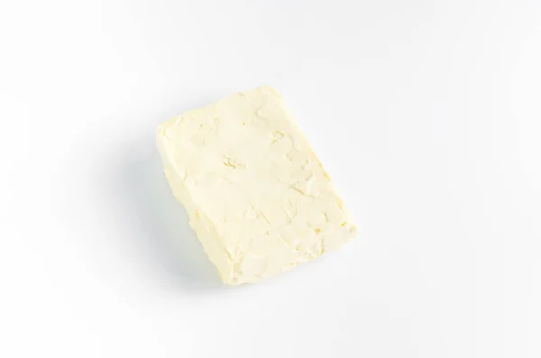 Un pezzo di burro sul bianco — Foto Stock