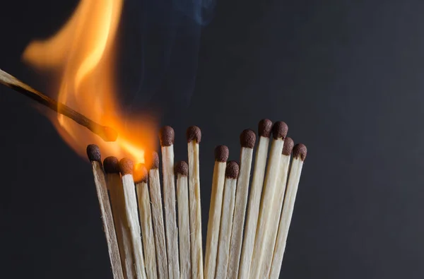 Burning matchstick on black background — Stock Photo, Image