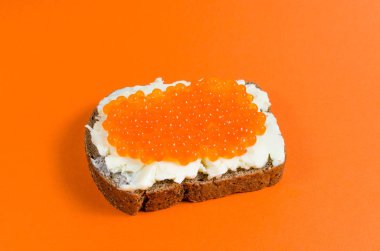 Siyah çavdar ekmeği, tereyağı ve kırmızı havyar ile bulaşmış bir parça