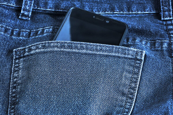 Cell phone, half peeking out of the back pocket of his jeans.