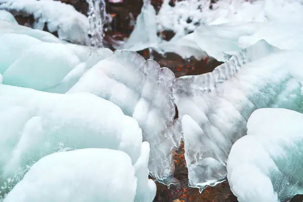 Frozen spring covered with pure blue ice. — Stock Photo, Image