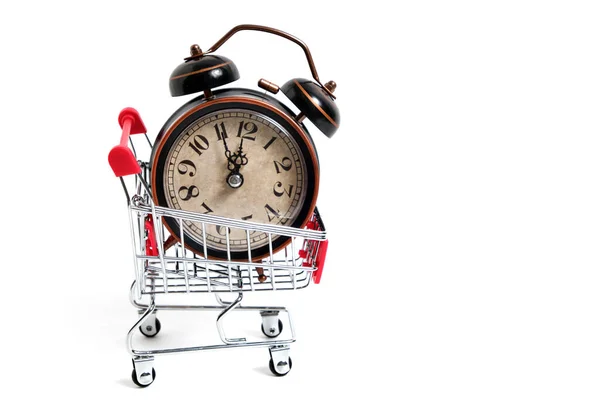 Retro alarm clock in shopping cart on white background. — Stock Photo, Image