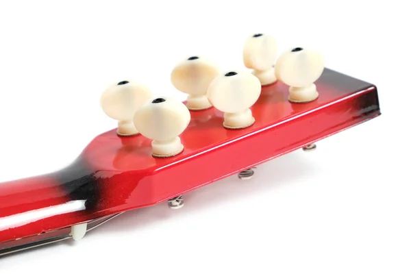 Red guitar tuning pegs for tensioning the strings on a white background. — ストック写真