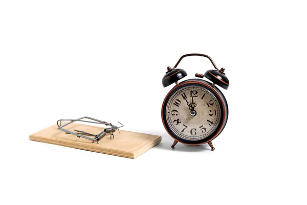 Relógio de alarme retro velho ao lado de ratoeira de madeira no fundo branco . — Fotografia de Stock