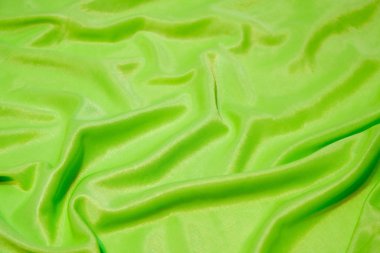 Doku, soyut arkaplan, ipek yeşil kumaş sanatsal olarak serilmiş..