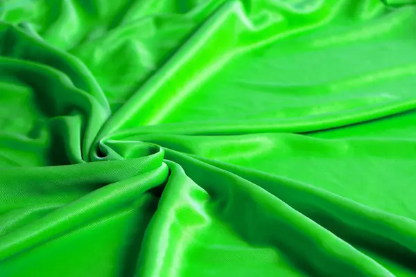 Textur, abstrakt bakgrund, silke grönt tyg konstnärligt upplagd. — Stockfoto