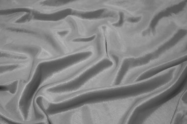 Doku, soyut arkaplan, sanatsal olarak serilmiş ipek gri kumaş..