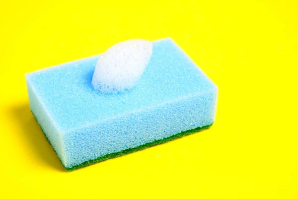 Blue sponge for washing dishes on a yellow background. — 스톡 사진