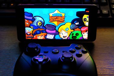 Kostanay, Kazakhstan, February 12, 2020.Joystick and mobile phone with the logo of the popular game Brawl Stars, from Supercell.